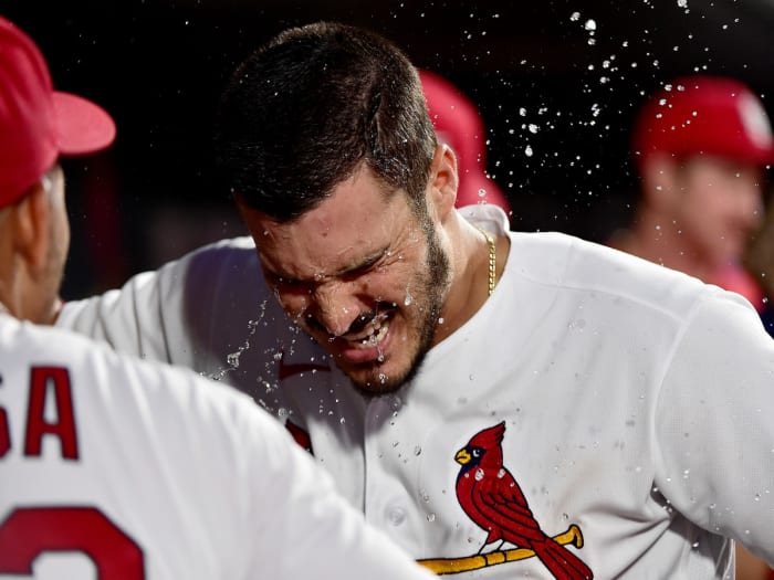Jun 25, 2021; St. Louis, Missouri, USA; St. Louis Cardinals third baseman Nolan Arenado (28) is splashed with water by shortstop Edmundo Sosa (63) after hitting a solo home run during the third inning against the Pittsburgh Pirates at Busch Stadium.